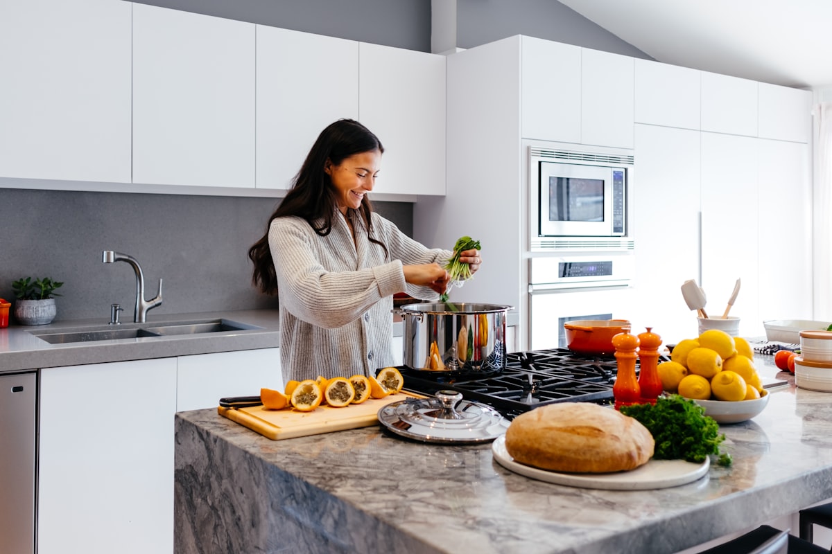 Professional chef demonstrating athletic nutrition cooking techniques in modern kitchen